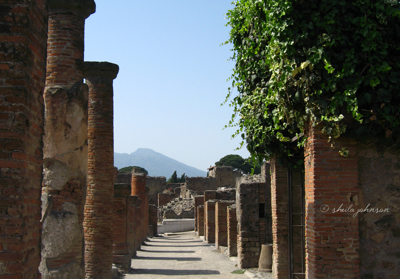 A Street In Pompeii, Italy, With Mount Vesuvius In The Background. The Eruption Of Mount Vesuvius In 79 A.d. Killed Everyone And Everything In Its Path.